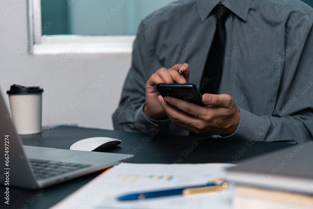 man using mobile smartphone working and digital online computer laptop at office man using mobile smartphone working and digital online computer laptop at office