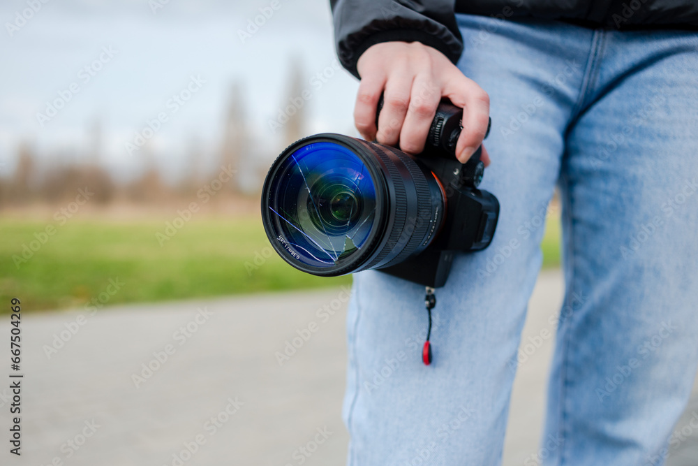 Fototapeta premium DSLR camera with broken lens filter. Cracked photo-filter