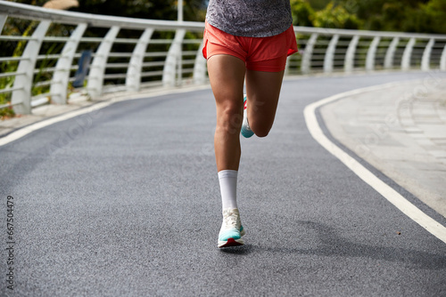 close-up shot of legs and feet of an asian woman jogging running outdoors