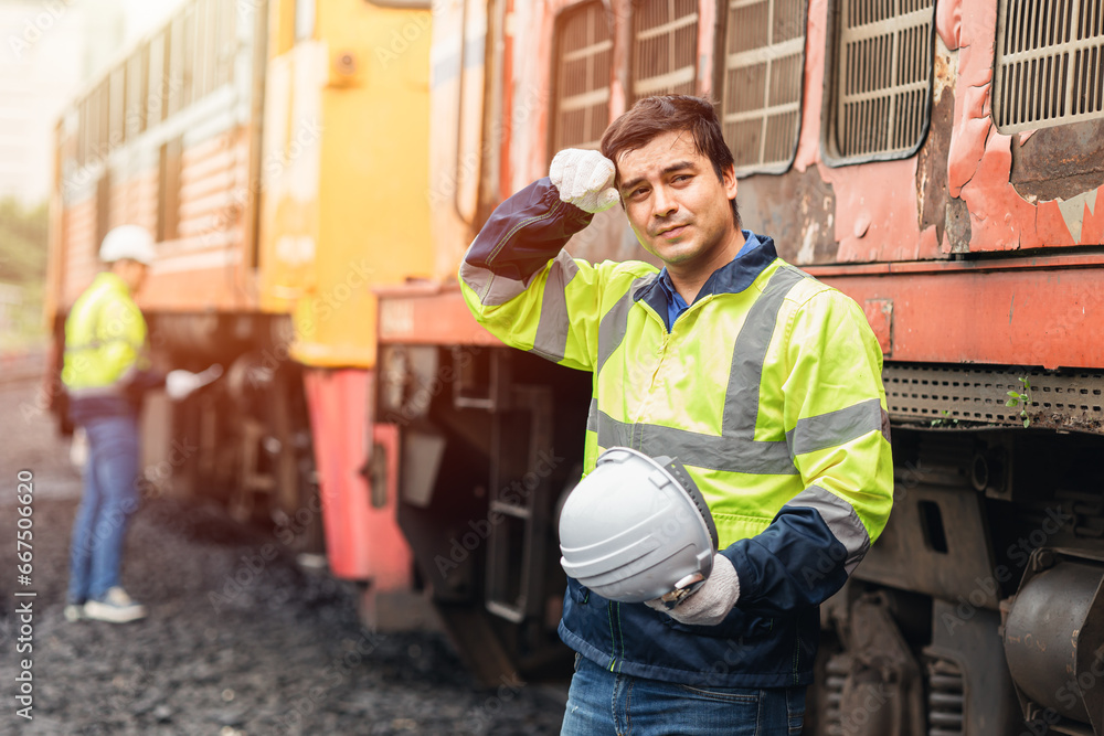 Tired fatigue engineer worker from outdoor hard work hot weather summer season train maintenance service staff. Tired fatigue engineer worker from outdoor hard work hot weather summer season train maintenance service staff.
