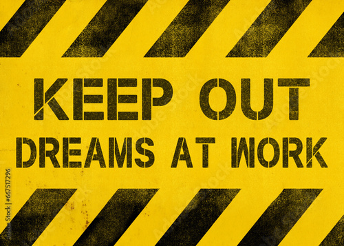 A funny inspirational message, the text Keep out, dreams at work, written over a yellow grunge background of diagonal stripes (recognizable pattern warning about danger). 