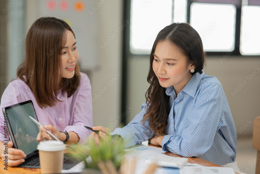 Young Asian business woman working and talking at the office
Young Asian business woman working and talking at the office