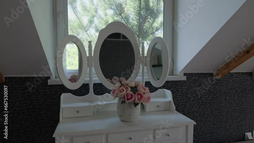 Side dolly shot of an oldstyle threesided open rounded mirror photo