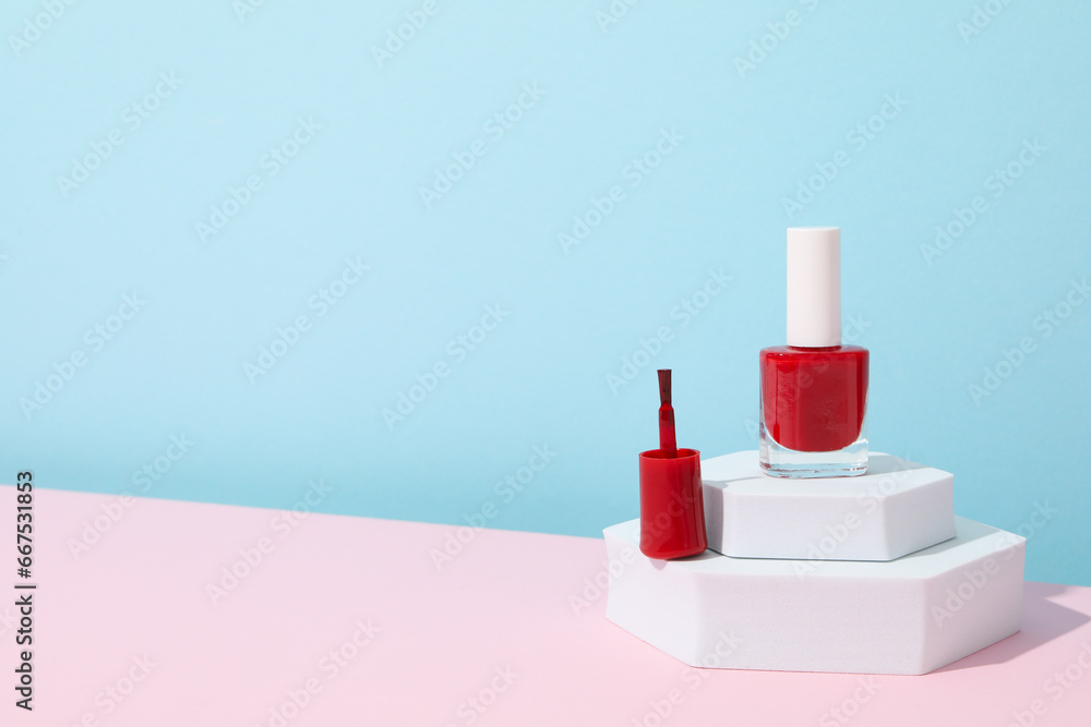 Red nail polish on a white podium Red nail polish on a white podium