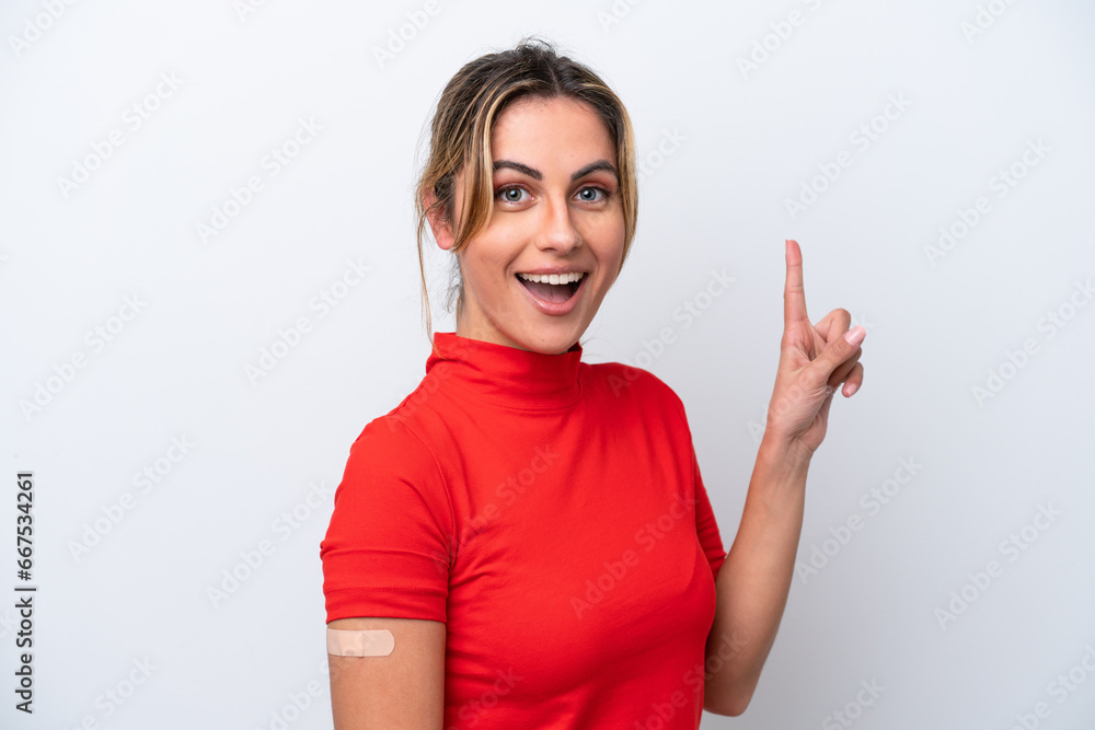 Young caucasian woman wearing band-aids isolated on white background pointing up a great idea Young caucasian woman wearing band-aids isolated on white background pointing up a great idea