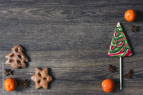 Christmas tree candy, mandarin, gingerbreads and anis on the dark wooden background. Christmas holidays. Winter. New year . Space for text