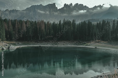 Small alpine lake surrounded by lush pine trees and mountains.