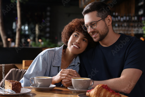 International dating. Lovely couple spending time together in cafe