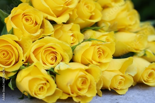 Beautiful bouquet of yellow roses on light table  closeup