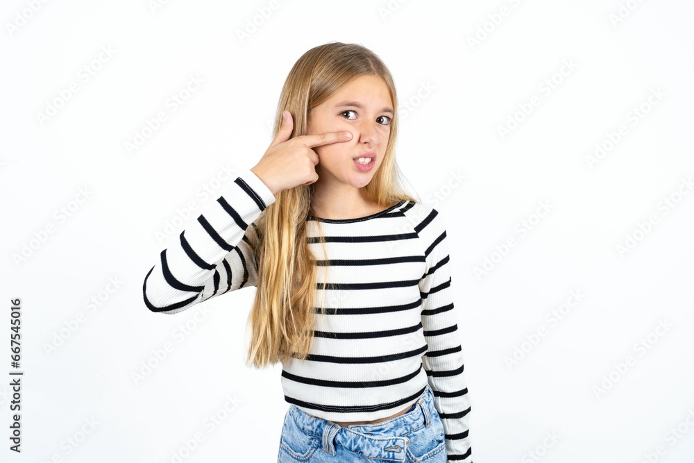Beautiful teen girl pointing unhappy to pimple on forehead, ugly infection of blackhead. Acne and skin problem Beautiful teen girl pointing unhappy to pimple on forehead, ugly infection of blackhead. Acne and skin problem