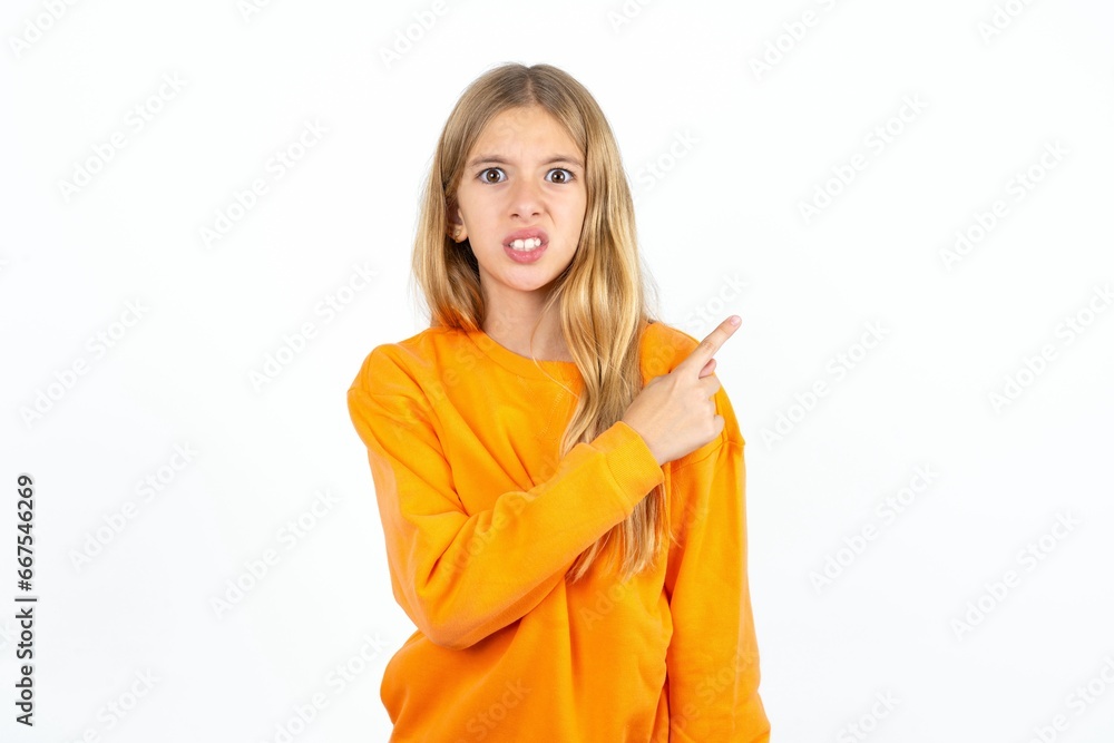 Beautiful teen girl Pointing aside worried and nervous with forefinger, concern and surprise concept. Beautiful teen girl Pointing aside worried and nervous with forefinger, concern and surprise concept.