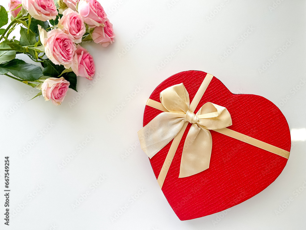 Gift box in the shape of a heart, flowers and ribbon on a light background. Gift for Valentine's Day, Mother's Day, Birthday, March 8th, Women's Day, card Gift box in the shape of a heart, flowers and ribbon on a light background. Gift for Valentine's Day, Mother's Day, Birthday, March 8th, Women's Day, card