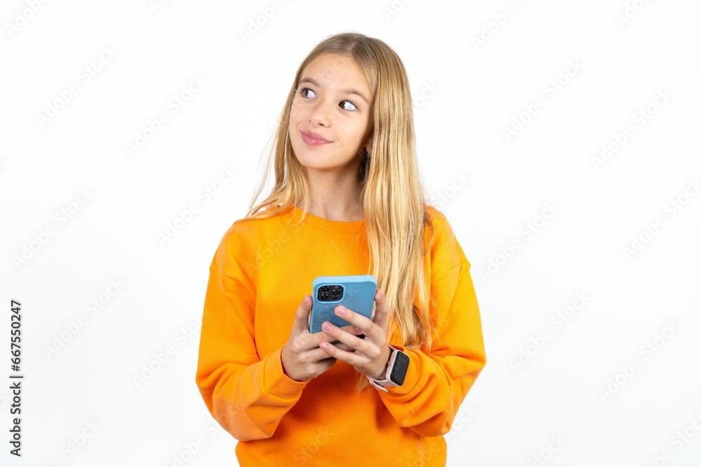 Beautiful teen girl holds telephone hands reads good youth news look empty space advert