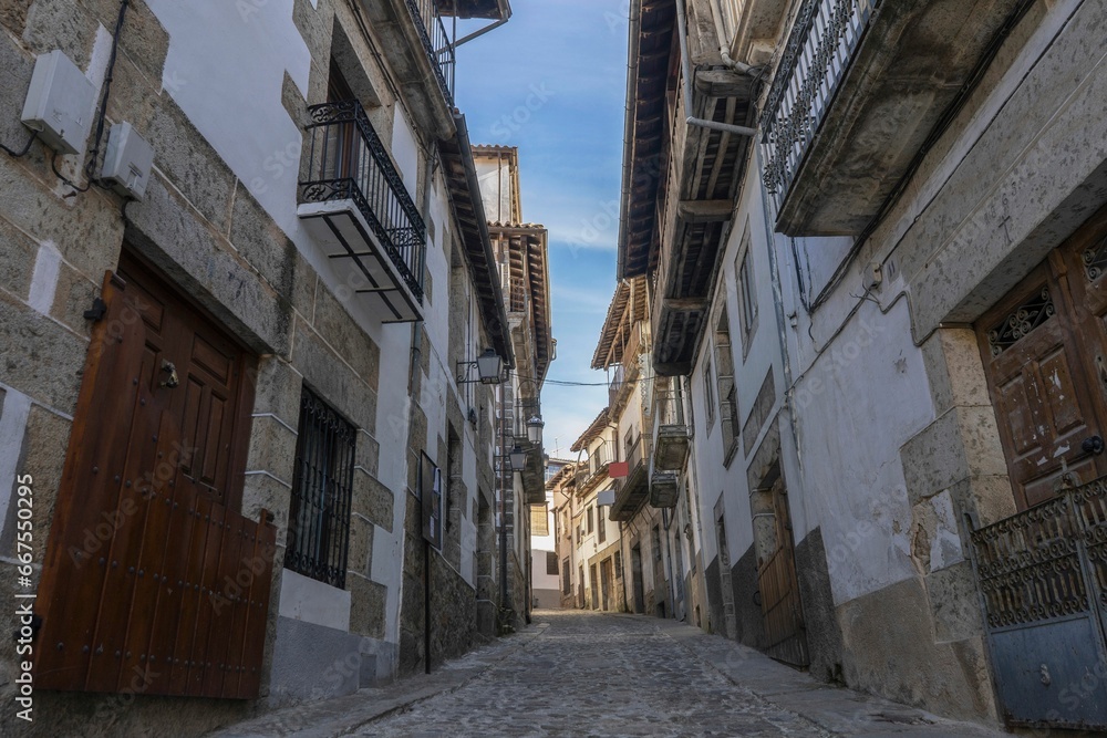 Stone street surrounded by old houses in the medieval village of Candelario, Salamanca, Spain