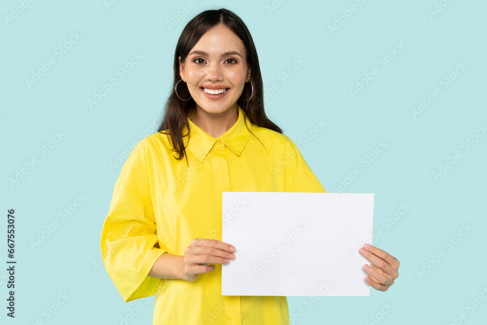 Smiling brunette lady demonstrating white empty billboard Smiling brunette lady demonstrating white empty billboard