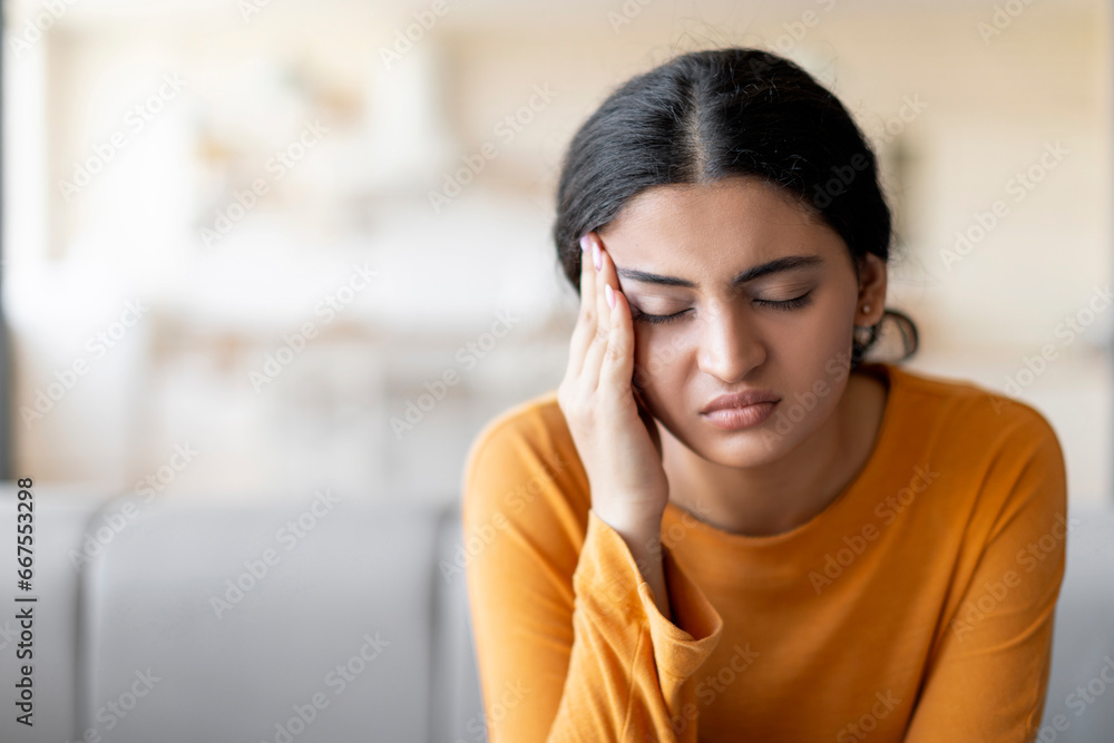 Stressed Young Indian Woman Suffering From Headache At Home Stressed Young Indian Woman Suffering From Headache At Home