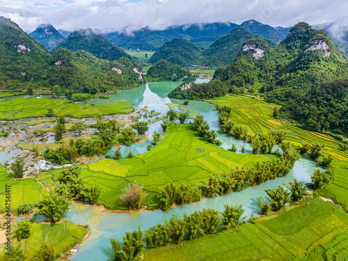 Aerial landscape in Quay Son river, Trung Khanh, Cao Bang, Vietnam with nature, green rice fields and rustic indigenous houses photo