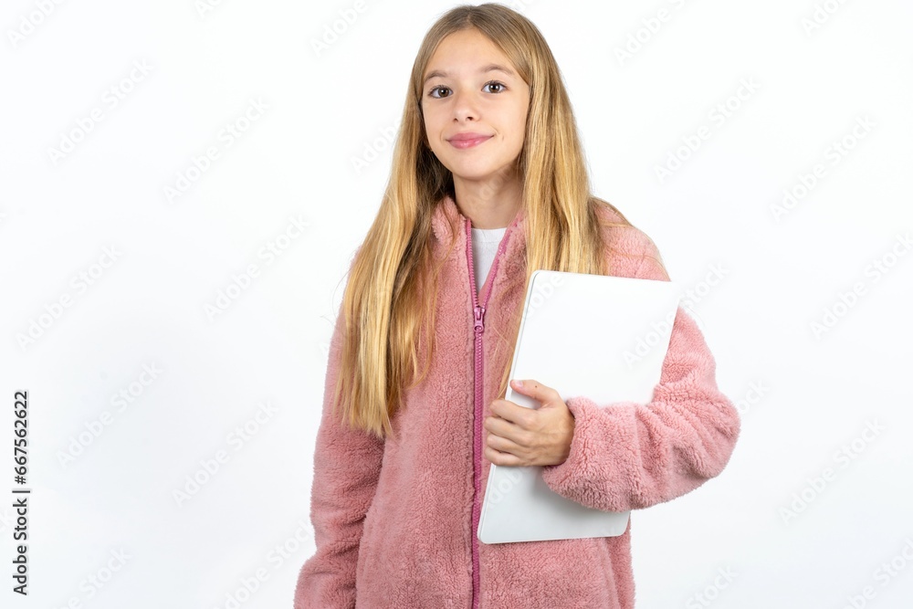 Beautiful caucasian teen girl holding laptop showing copy empty space ad Beautiful caucasian teen girl holding laptop showing copy empty space ad