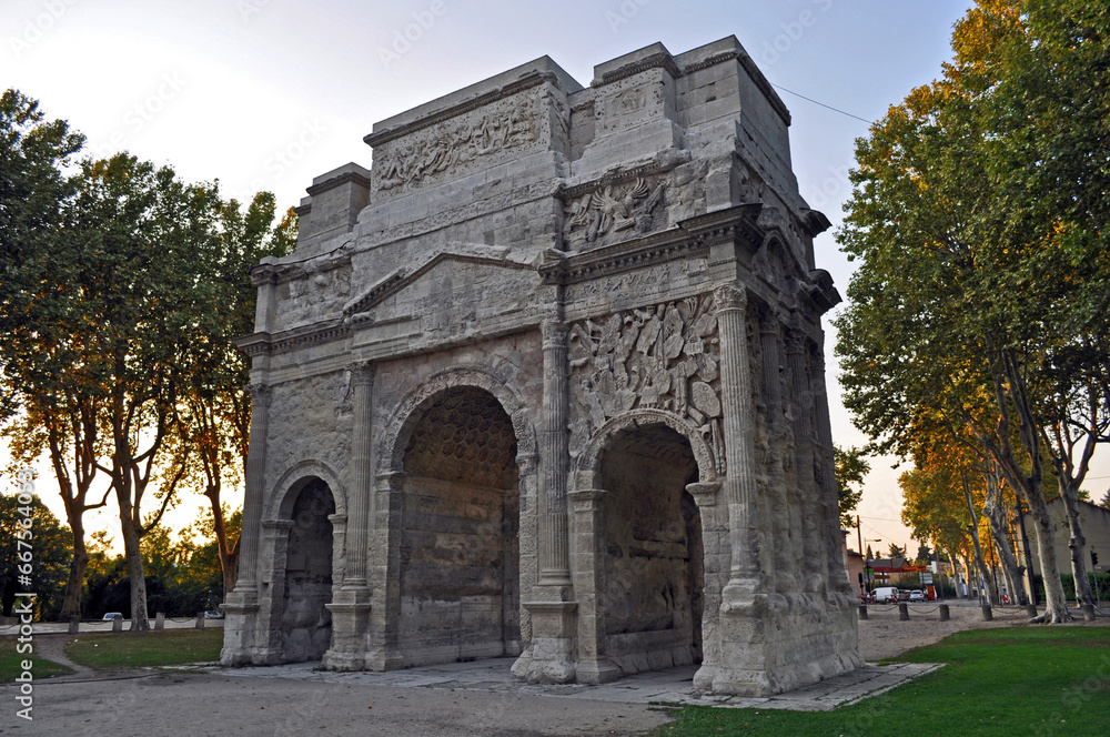 Arc de Triomphe in Orange, France. Historical memorial building in the evening at sunset.