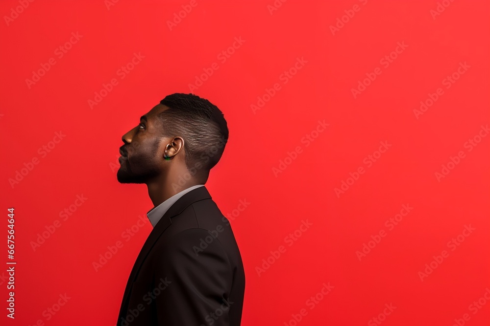 Obraz premium portrait of a man in profile isolated on a red background