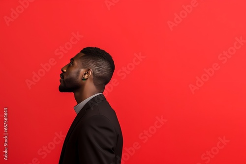 portrait of a man in profile isolated on a red background