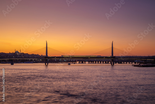 Obraz na płótnie Golden Horn metro bridge across the bay illuminated at sunset, Istanbul, Turkey w salonie
