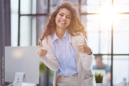 Proud office worker posing with thumbs up