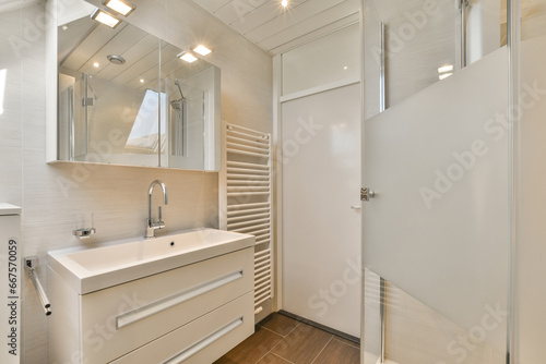 a bathroom with a sink and mirror on the wall next to it is an open door that leads to a walk - in shower