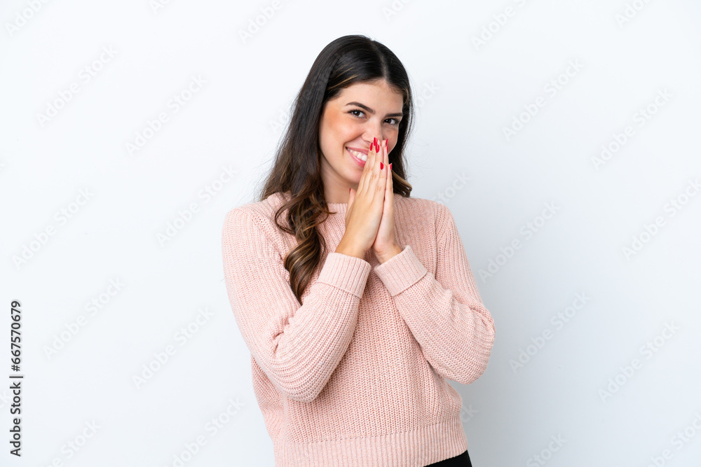 Young Italian woman isolated on white background keeps palm together. Person asks for something Young Italian woman isolated on white background keeps palm together. Person asks for something