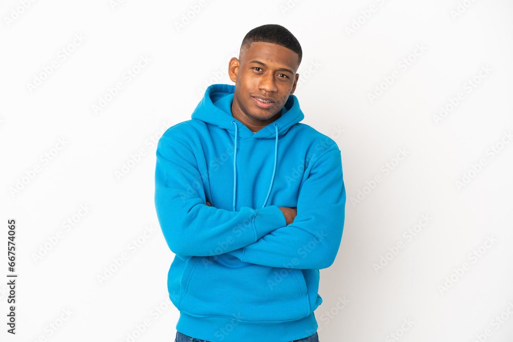Young latin man isolated on white background keeping the arms crossed in frontal position Young latin man isolated on white background keeping the arms crossed in frontal position