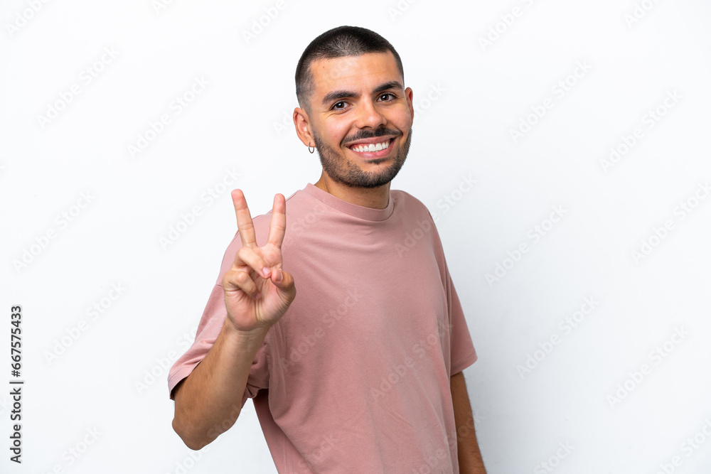 Young caucasian man isolated on white background smiling and showing victory sign Young caucasian man isolated on white background smiling and showing victory sign