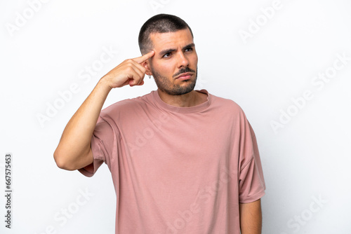 Young caucasian man isolated on white background making the gesture of madness putting finger on the head