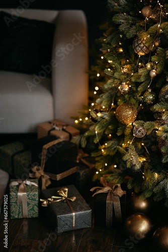 christmas tree with gifts at a cozy salon with low light