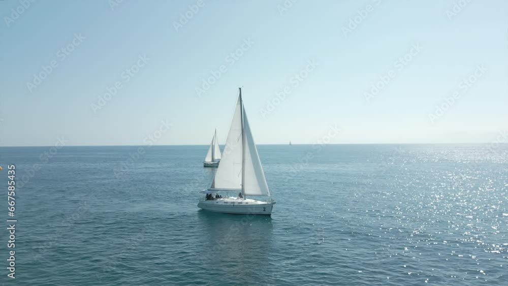 Yacht with white sails at sea. Yachting, luxury vacation and regatta at Cambrils Yacht with white sails at sea. Yachting, luxury vacation and regatta at Cambrils