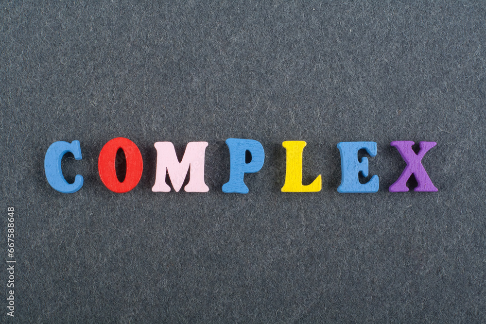 COMPLEX word on black board background composed from colorful abc alphabet block wooden letters, copy space for ad text. Learning english concept. COMPLEX word on black board background composed from colorful abc alphabet block wooden letters, copy space for ad text. Learning english concept.