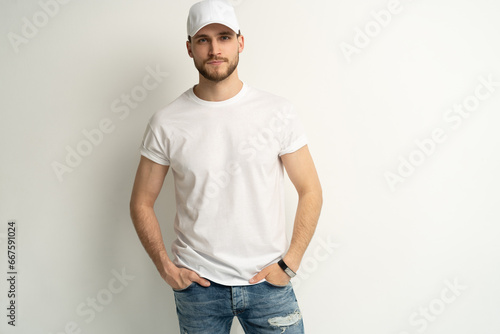 Handsome man wearing blank white cap and white t-shirt isolated on white background. photo