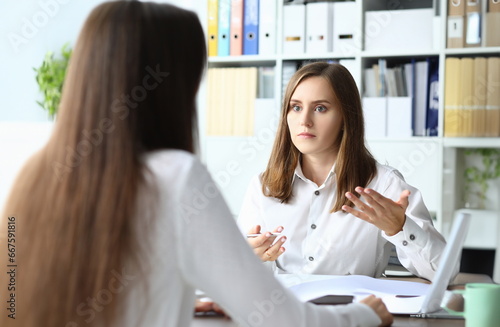 Free Download Portrait of smart businesspeople sitting in modern workplace and talking about tactics and profits in paper tablet with significant charts. Accounting office concept - GFXLoad