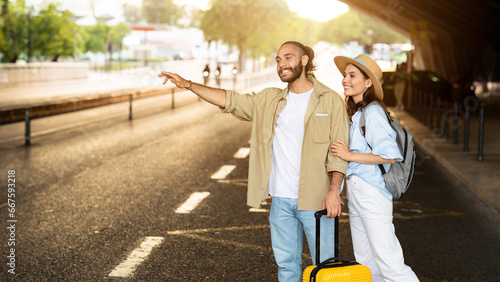 Cheerful millennial european family tourists with suitcase stop taxi, wait transport on station #667593218