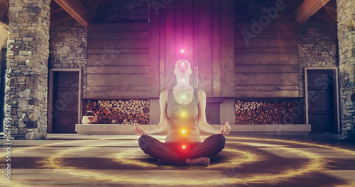 Beautiful Relaxed Caucasian Woman In Lotus Position Meditating In Zenlike Openair Space. Edited Visualization Of Multi Colored Chakras Glowing On Her Body. Spirituality, Yoga, Self-care Concept. photo