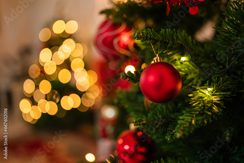 New Year concept Close up of balls on christmas tree. Bokeh garlands in the background.