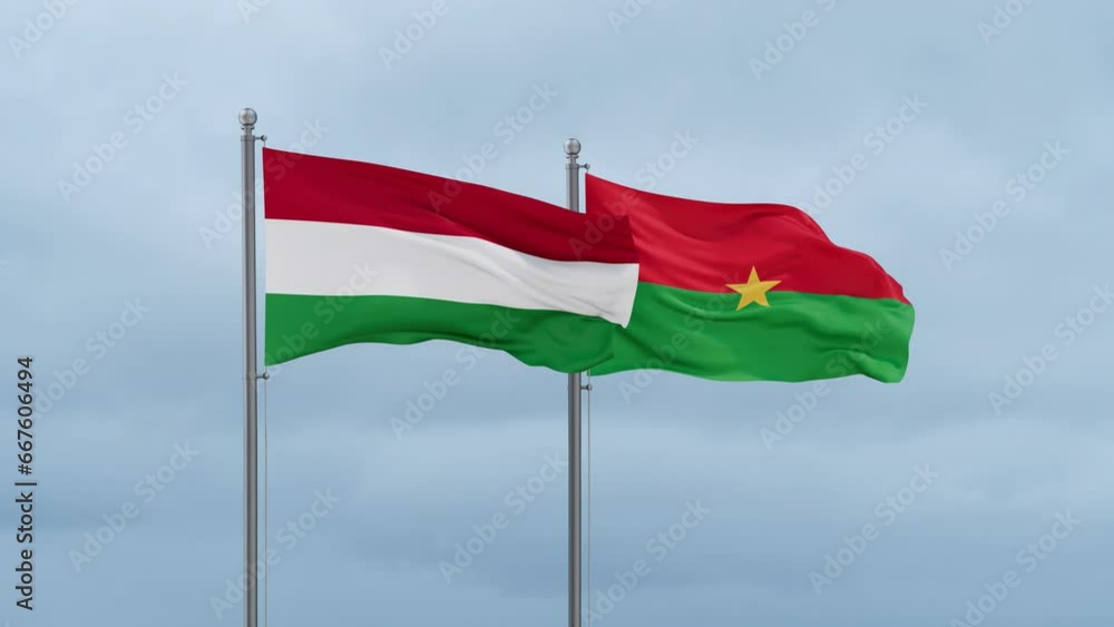 Burkina Faso flag and Hungary flag waving together on cloudy sky, endless seamless loop, two country relations concept Burkina Faso flag and Hungary flag waving together on cloudy sky, endless seamless loop, two country relations concept