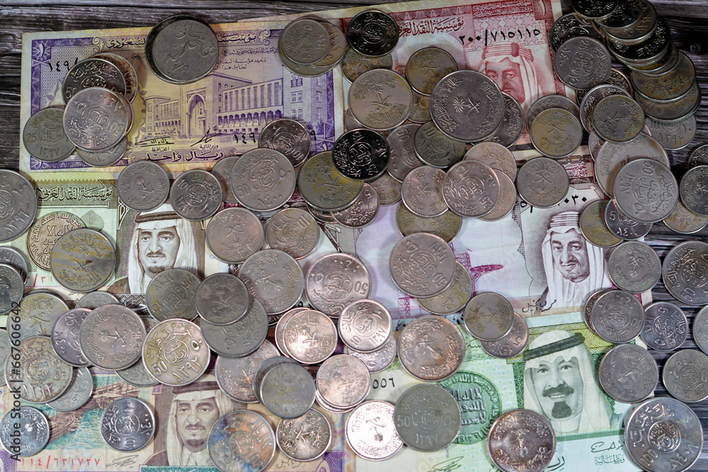 Saudi Arabia riyals money banknote bills and coins of different eras from the kingdom of Saudi