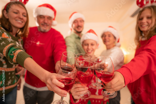 Group of happy family smiling happy celebrating christmas toasting with wine. Family member enjoy home made turkry grill dining togather at home. Christmas and New Year interior concept.