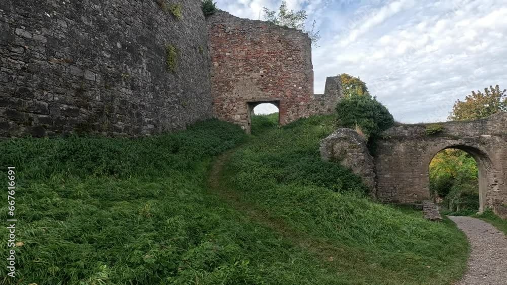 Castle ruins in the park with old walls and autumn trees Castle ruins in the park with old walls and autumn trees