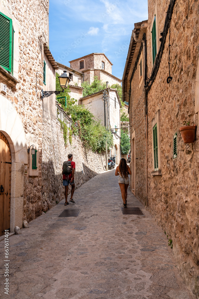 Rear view of tourists exploring Valldemosa village on Majorca island, Spain