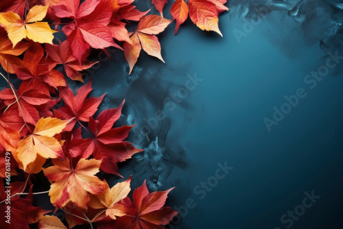 Colorful autumn leafs on a blue background of slate rock symbolizing change of seasons.