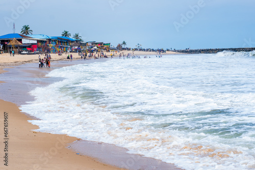 Waves gently roll along the shoreline beach in Lagos, Nigeria, November 2019. Holiday season in Lekki