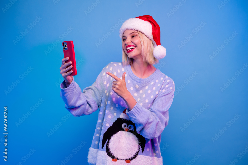 Obraz premium Photo of cheerful charming girl wear trendy penguin ornament jumper speaking online video call isolated blue color neon light background