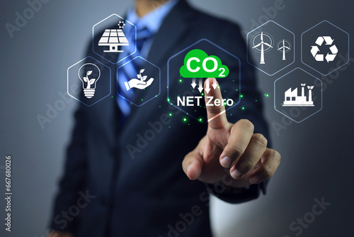 CO2 net zero emission concept. Businessman pointing on renewable clean energy technology and sustainable development with environmental friendly to reduce global warming and climate change