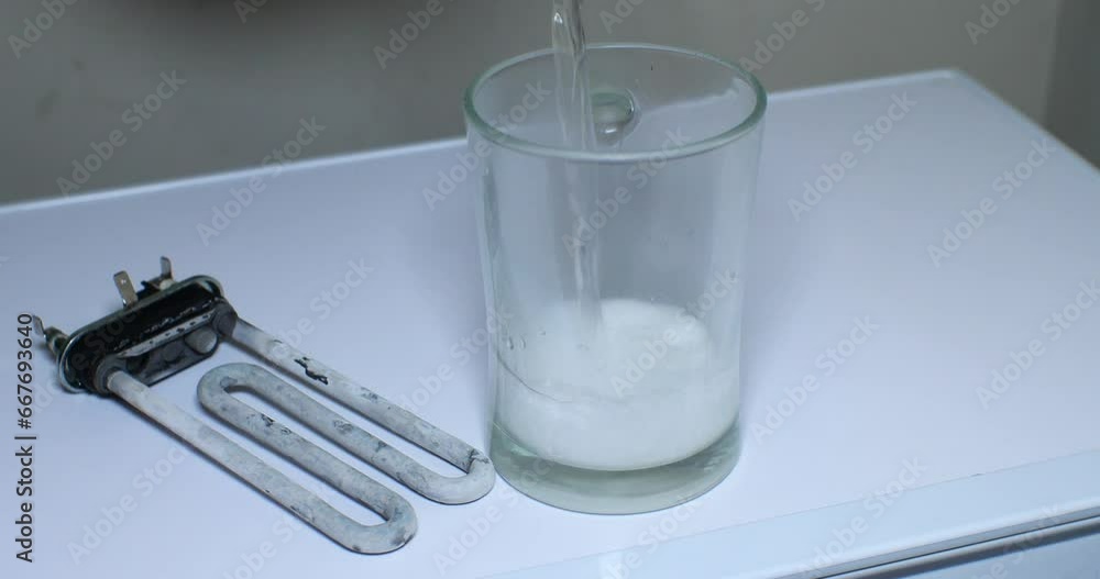 A broken heating element from a washing machine with limescale deposits